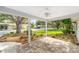 View from the bricked, covered patio onto a quiet street with lush landscaping at 8998 Sw 94Th St # D, Ocala, FL 34481