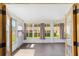 Bright sunroom filled with natural light from large windows, with door to backyard at 8998 Sw 94Th St # D, Ocala, FL 34481