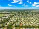 This aerial shows the home in a developed neighborhood, featuring tree-lined streets, manicured lawns, and diverse architecture at 9131 Se 135Th St, Summerfield, FL 34491