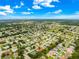 Overhead view of the neighborhood showcases single-Gathering homes with mature trees, manicured lawns, and wide streets under a blue sky at 9131 Se 135Th St, Summerfield, FL 34491