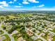 Aerial view shows the home's location in a leafy residential neighborhood, with mature trees and a golf course nearby at 9131 Se 135Th St, Summerfield, FL 34491