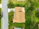 Aerial perspective of the home with the roof and manicured lawn. The house is in a lush, green neighborhood at 9131 Se 135Th St, Summerfield, FL 34491