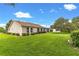 Expansive lawn with meticulously manicured landscaping surrounding the home's exterior at 9131 Se 135Th St, Summerfield, FL 34491