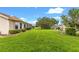 Lush green backyard showcasing the well maintained lawn and manicured landscaping of the property at 9131 Se 135Th St, Summerfield, FL 34491