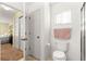 Bright bathroom with toilet, window, closet access, and bedroom access at 9131 Se 135Th St, Summerfield, FL 34491