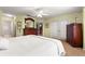 Spacious bedroom with carpet flooring, ceiling fan, and large dresser at 9131 Se 135Th St, Summerfield, FL 34491