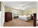 Bright bedroom with bay window, carpet flooring, ceiling fan, and light yellow walls at 9131 Se 135Th St, Summerfield, FL 34491