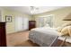Bright bedroom with bay window, carpet flooring, ceiling fan, and light yellow walls at 9131 Se 135Th St, Summerfield, FL 34491