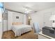 Bright bedroom with a Murphy bed, built-in shelving, and a ceiling fan above at 9131 Se 135Th St, Summerfield, FL 34491