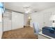 Bright bedroom with a Murphy bed, built-in shelving, and brown carpet at 9131 Se 135Th St, Summerfield, FL 34491