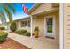 Inviting front porch with decorative pot, tidy landscaping, and a welcoming entrance to the home at 9131 Se 135Th St, Summerfield, FL 34491