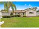 Charming beige home with manicured lawn and landscape, showcasing a cozy and well-maintained exterior at 9131 Se 135Th St, Summerfield, FL 34491