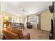 Large living room featuring multiple seating options, a ceiling fan, and ample space for gatherings at 9131 Se 135Th St, Summerfield, FL 34491