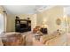 Bright living room featuring comfortable seating, entertainment center, and plenty of natural light at 9131 Se 135Th St, Summerfield, FL 34491