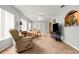 Cozy living room with large windows, ceiling fan, and neutral-toned furniture at 9131 Se 135Th St, Summerfield, FL 34491