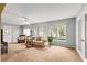 Bright living room with natural light, carpet, and light blue walls at 9131 Se 135Th St, Summerfield, FL 34491