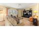Cozy living room featuring comfortable seating, entertainment center, and plenty of natural light at 9131 Se 135Th St, Summerfield, FL 34491