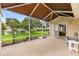 Neutral speckled patio with an exterior view, shade screen, and an entrance into the living room at 9131 Se 135Th St, Summerfield, FL 34491