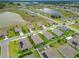 A picturesque aerial view of a neighborhood with green lawns, mature landscaping and a community pond at 9237 Sw 60Th Terrace Rd, Ocala, FL 34476