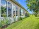 Lush backyard featuring a well-manicured lawn, flower beds, and mature trees at 9237 Sw 60Th Terrace Rd, Ocala, FL 34476