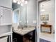 Charming bathroom with a granite countertop vanity and an entryway view into the hallway with a table at 9237 Sw 60Th Terrace Rd, Ocala, FL 34476