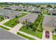 Landscaped home featuring a well manicured lawn, decorative shrubbery, and mature palms at 9237 Sw 60Th Terrace Rd, Ocala, FL 34476
