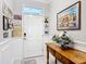 Bright foyer with tile flooring, chair rail, a decorative table with flowers, and amusing decorative wall art at 9237 Sw 60Th Terrace Rd, Ocala, FL 34476