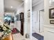 Hallway featuring decorative molding, neutral paint, tile flooring, a grandfather clock and a view to the living area at 9237 Sw 60Th Terrace Rd, Ocala, FL 34476