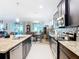 Open kitchen with granite counters, stainless appliances, and tile backsplash overlooking breakfast area at 9237 Sw 60Th Terrace Rd, Ocala, FL 34476