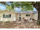 View of backyard with patio area, grill, and mature trees providing ample shade at 9290 Sw 89Th Ter # D, Ocala, FL 34481