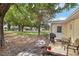 Relaxing backyard featuring mature trees, lawn, and cozy patio with grill and seating at 9290 Sw 89Th Ter # D, Ocala, FL 34481