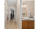 Bathroom sink area showing view into the hall at 9290 Sw 89Th Ter # D, Ocala, FL 34481