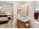 Bathroom with a modern sink and view into the bedroom at 9290 Sw 89Th Ter # D, Ocala, FL 34481