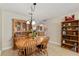 Comfortable dining area with wooden table and chairs and a view of the updated kitchen at 9290 Sw 89Th Ter # D, Ocala, FL 34481