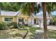 Lovely yellow home with a well-kept lawn, a cozy porch, and mature landscaping at 9290 Sw 89Th Ter # D, Ocala, FL 34481