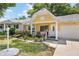 Quaint yellow home featuring a manicured lawn and an inviting front porch at 9290 Sw 89Th Ter # D, Ocala, FL 34481