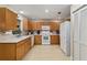 Well-lit kitchen with white appliances, bright cabinetry and easy access to storage at 9290 Sw 89Th Ter # D, Ocala, FL 34481