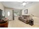 Cozy living room with a large window for natural light, a ceiling fan and comfortable seating at 9290 Sw 89Th Ter # D, Ocala, FL 34481