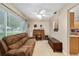 Comfortable living room with a brown sofa, a ceiling fan, and a view into the adjacent kitchen at 9290 Sw 89Th Ter # D, Ocala, FL 34481