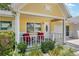 Charming porch featuring cozy chairs, lush landscaping, and a welcoming entrance at 9290 Sw 89Th Ter # D, Ocala, FL 34481