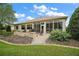 Spacious backyard showcasing a patio, lush lawn, manicured landscaping and the rear of the house at 9459 Se 124Th Loop, Summerfield, FL 34491