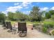 Beautiful landscaped backyard with lush lawn, flower beds, an arbor and brick patio with seating at 9459 Se 124Th Loop, Summerfield, FL 34491
