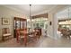 Elegant dining room features hardwood floors, a decorative light fixture, and ample natural light at 9459 Se 124Th Loop, Summerfield, FL 34491