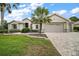 Beautiful single-story home features a manicured lawn, mature landscaping, and a neutral color palette at 9459 Se 124Th Loop, Summerfield, FL 34491
