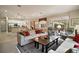 Open-concept living room boasts an airy feel with hardwood floors and seamless flow to other living spaces at 9459 Se 124Th Loop, Summerfield, FL 34491
