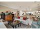 Spacious living room showcases hardwood floors, a neutral color palette, and an open design at 9459 Se 124Th Loop, Summerfield, FL 34491
