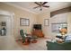 Cozy sitting room with comfortable seating, hardwood floors, and an abundance of natural light at 9459 Se 124Th Loop, Summerfield, FL 34491