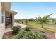 Landscaped backyard with a view of the screened-in porch and surrounding neighborhood at 9607 Sw 79Th Lane Rd, Ocala, FL 34481