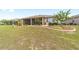 Well-maintained backyard showcasing lush green grass, landscaping, and a view of the screened-in patio at 9607 Sw 79Th Lane Rd, Ocala, FL 34481