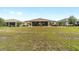 Expansive backyard with lush green grass and neatly manicured landscaping, offering a peaceful outdoor retreat at 9607 Sw 79Th Lane Rd, Ocala, FL 34481